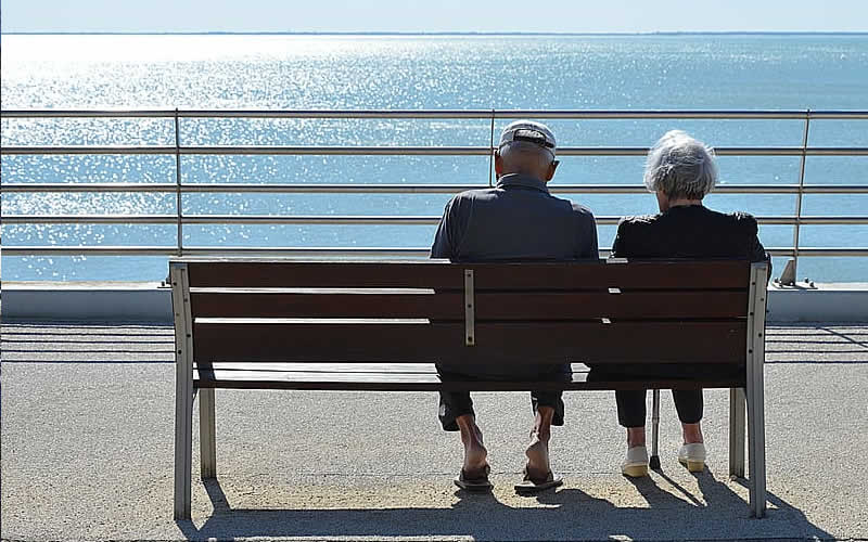 Couple sitting overlooking the seaside