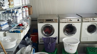 Shared laundry room with a system to make sharing easy.