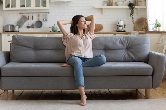 Woman on sofa looking relaxed and happy