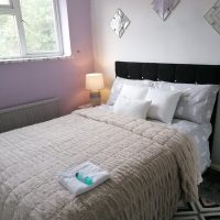 Pink wall and window in bedroom in Northampton