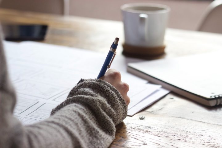 Female hand writing with pen and paper