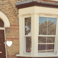 Bay window and front door of house share