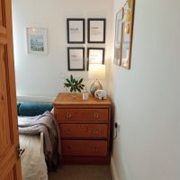 view of dresser and bed in spare room