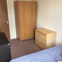 Room with double bed, wardrobe and draws