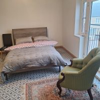 Well decorated double room with chair and window