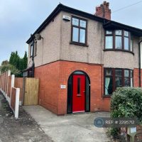 Outside of a semi with red door and concreted drive