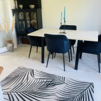 Dining room table and chairs with stripey carpet