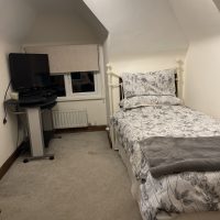 Room under the eaves, with large TV