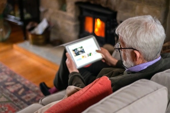 Man on sofa with tablet